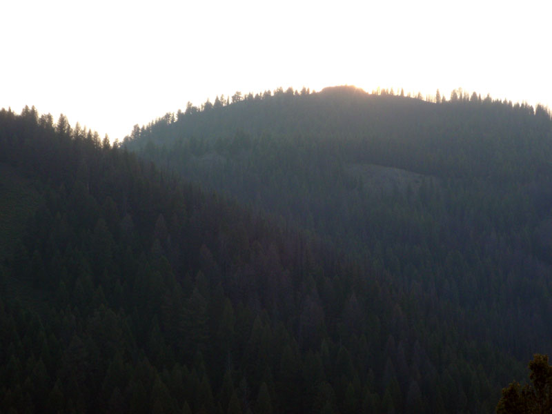 Sun sets behind western hills