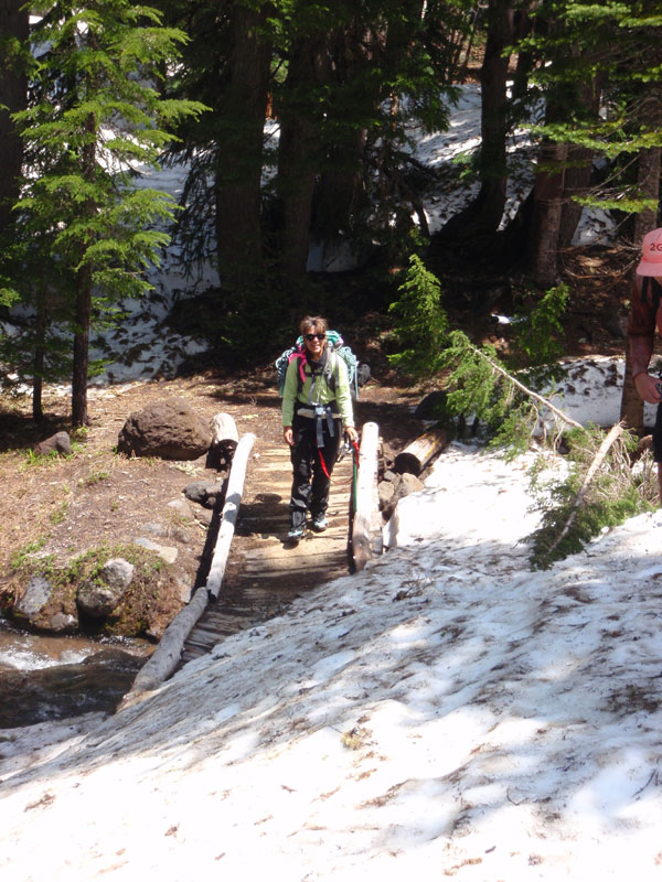 Juli crosses broken bridge on the PCT