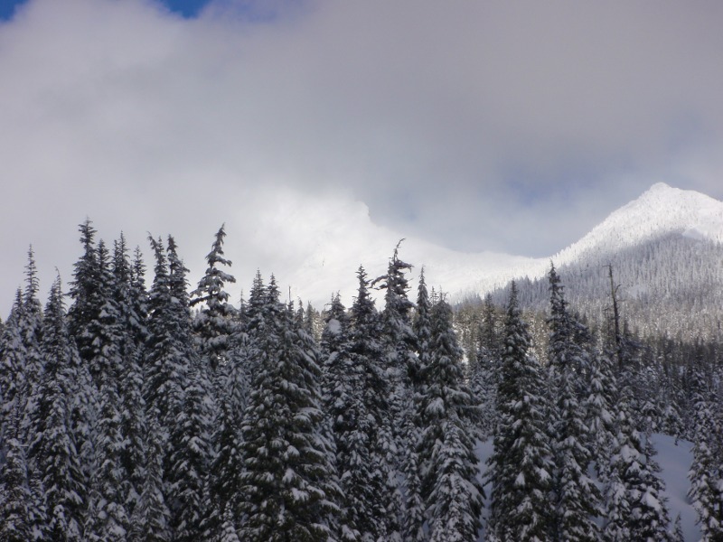 A bit of Three Fingered Jack shows through the clouds