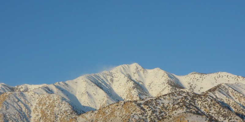 Wisps of wind-blown snow over Sierras